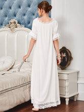 Back view of a woman wearing a beautiful ankle length soft cotton nightgown trimmed in soft lace. Can be worn on or off the shoulder. Light, comfy and elegant.
