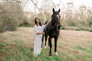 Beautiful ankle length soft cotton nightgown trimmed in soft lace. Can be worn on or off the shoulder. Light, comfy and elegant. In this image a lovely lady is wearing a gown while standing next to a stunning horse.