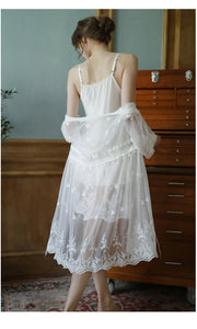 Back view of a beautiful woman wearing white lacey short nightgown and robe set.