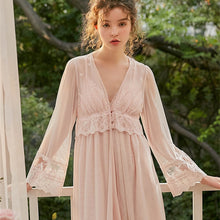 This elegant peignoir is the ultimate in feminine grace. The transparent robe features a gorgeous, embroidered bodice punctuated by three pearl buttons and a beautiful ruffle. The robe is a simple design of soft material, with spaghetti straps and deep v-neck trimmed with soft scalloped lace. .