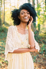 This elegant nightgown is a two-piece set with a lovely silky satin chemise that's worn under a soft, stretchy textured layer of pure golden glamour.  The champagne-colored chemise has adjustable spaghetti straps and falls above the knee. The soft, stretchy overlayer falls low to mid-calf. It's graceful and flowing with three-quarter bell sleeves and waist tie. It's gorgeous ya'll!