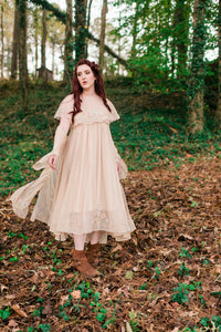 Woman floating down a hill in a three piece nightgown set. Three pieces include a beautiful Gown, Robe and Neck shawl. Layers of golden organza trimmed in delicate Victoria embroidery.