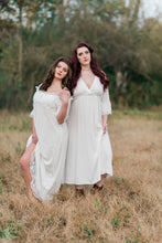 Beautiful, full figured woman in light and airy white nightgown. The gown has three-quarter sleeves with a white embroidered trim, a pretty v-neckline trimmed with white embroidery and an empire waist with embroidered trim.