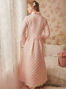 Back view of Margaret Lawton's Warmth. Ruffled cuffs and collar add a feminine touch, and satin bows at the waist and sleeves transform this winter robe into something quite fancy.