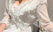 Close up detail of ruffles on elegant chiffon robe.