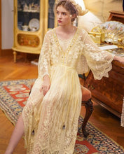 This elegant nightgown is a two-piece set with a lovely silky satin chemise that's worn under a soft, stretchy textured layer of pure golden glamour.  The champagne-colored chemise has adjustable spaghetti straps and falls above the knee. The soft, stretchy overlayer falls low to mid-calf. It's graceful and flowing with three-quarter bell sleeves and waist tie. It's gorgeous ya'll