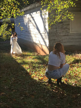 Photographer shooting images of a beautiful woman in Margaret Lawton's Romantic White Peignoir.