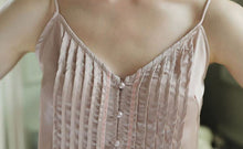Close up of  Margaret Lawton's Glamorous Satin Pajama top with flat fell seams, pearl buttons and spaghetti straps.