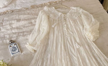 Close up of the robe of Margaret Lawton's Romantic White Peignoir. Enjoy the feminine beauty of this vintage style, glamorous white peignoir. The robe is made from a soft and stretchy, intricate lace, with embroidered-trim and a ruffled hem.  You'll feel uplifted and special, and look angelically alluring as you float gracefully around in these lovely layers of softness.