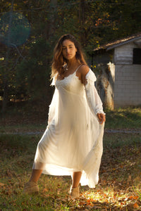 Enjoy the feminine beauty of this vintage style, glamorous white peignoir. It's a perfect gift for yourself or someone special. The robe is made from a soft and stretchy, intricate lace, with embroidered-trim and a ruffled hem. The gown has adjustable straps with a beautiful lace bodice and a double layered gown. It falls mid-calf.  You'll feel uplifted and special, and look angelically alluring as you float gracefully around in these lovely layers of softness.