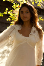 Enjoy the feminine beauty of this vintage style, glamorous white peignoir. It's a perfect gift for yourself or someone special. The robe is made from a soft and stretchy, intricate lace, with embroidered-trim and a ruffled hem. The gown has adjustable straps with a beautiful lace bodice and a double layered gown. It falls mid-calf.  You'll feel uplifted and special, and look angelically alluring as you float gracefully around in these lovely layers of softness.