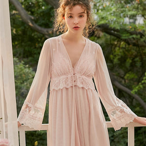 This elegant peignoir is the ultimate in feminine grace. The transparent robe features a gorgeous, embroidered bodice punctuated by three pearl buttons and a beautiful ruffle. The robe is a simple design of soft material, with spaghetti straps and deep v-neck trimmed with soft scalloped lace. .  