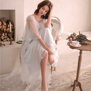 Image of a woman in a chair wearing a Dreamy Margaret Lawton Nightgown.  Transparent chiffon trimmed with satin ribbon overlays cotton underlayer.